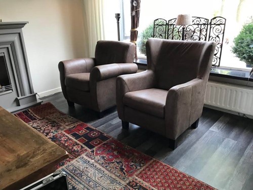 Set van 2 verschillende leren fauteuils met houten poten - bruin leer